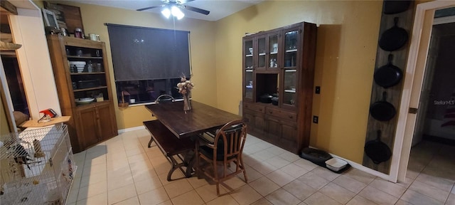 dining room with light tile patterned floors, baseboards, and a ceiling fan