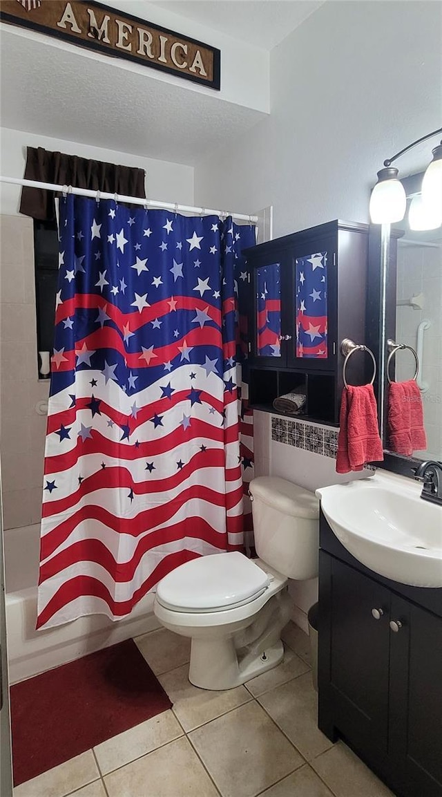 full bath featuring shower / bath combo with shower curtain, toilet, vanity, and tile patterned flooring