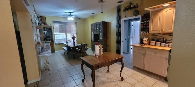 kitchen featuring tasteful backsplash, wooden counters, light brown cabinets, light tile patterned floors, and a ceiling fan