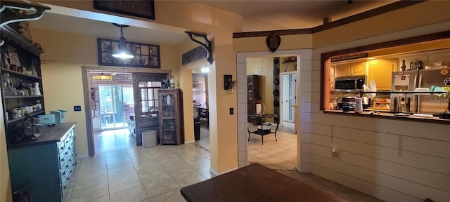 interior space featuring pendant lighting, dark countertops, and appliances with stainless steel finishes