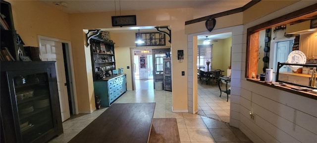 interior space with wine cooler and light tile patterned flooring