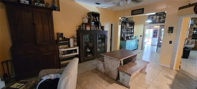 interior space featuring light tile patterned floors, visible vents, and a ceiling fan