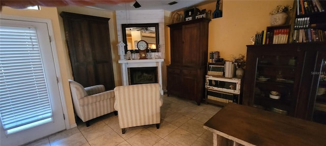 living area with light tile patterned floors and a fireplace