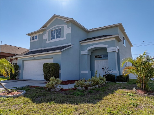 traditional home with a front lawn, a garage, driveway, and stucco siding