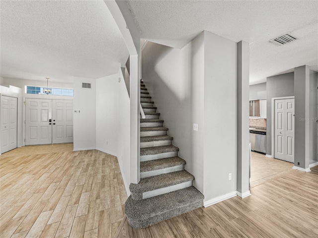 interior space featuring visible vents, baseboards, and wood finished floors