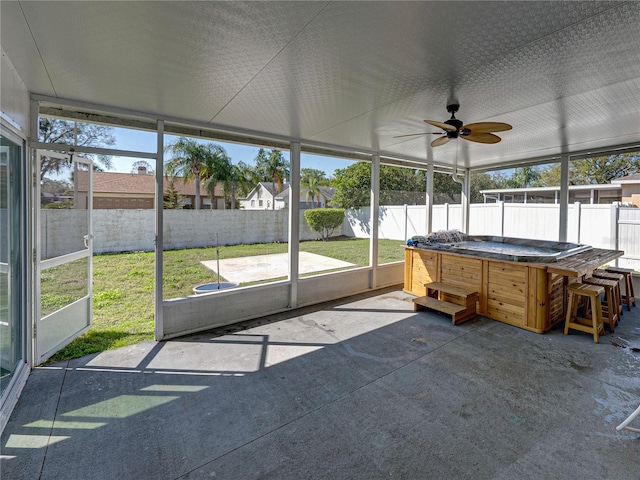 unfurnished sunroom with a ceiling fan