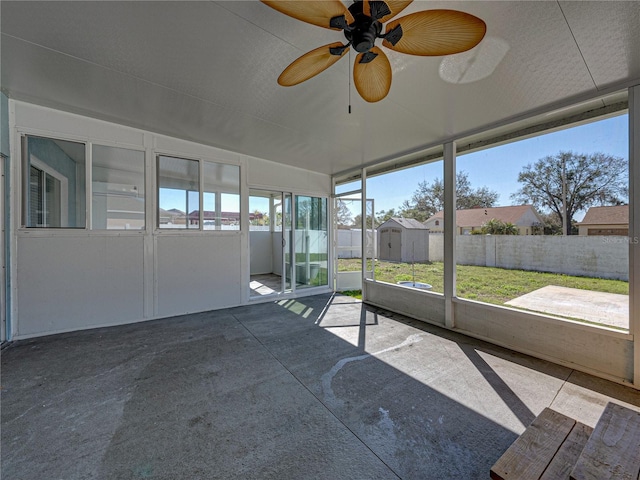 unfurnished sunroom featuring a ceiling fan