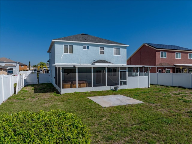 back of property with a sunroom, a fenced backyard, and a yard