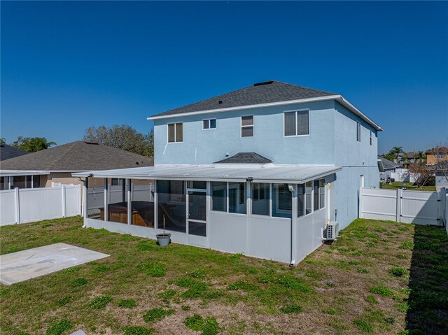 back of property featuring a patio, a sunroom, a fenced backyard, a gate, and a yard