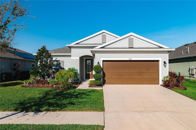 ranch-style home with a garage, concrete driveway, a front lawn, and stucco siding