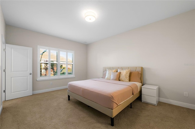 carpeted bedroom featuring baseboards