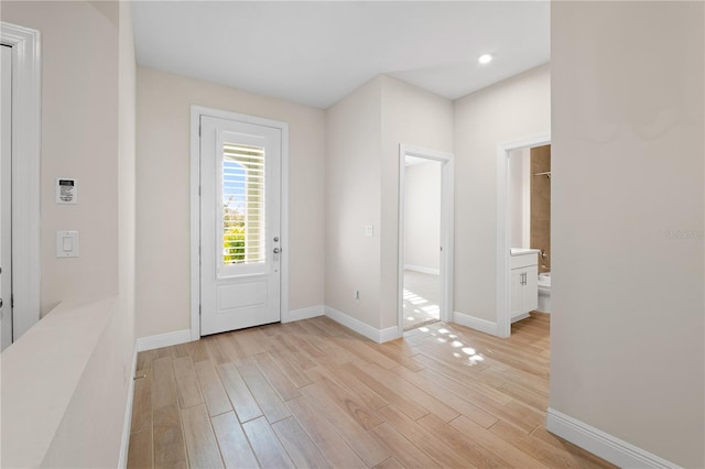 foyer featuring light wood-type flooring and baseboards