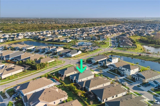 drone / aerial view with a water view and a residential view