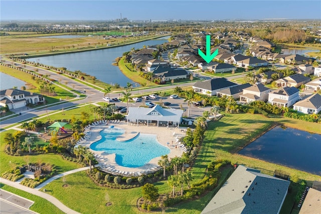 drone / aerial view with a water view and a residential view