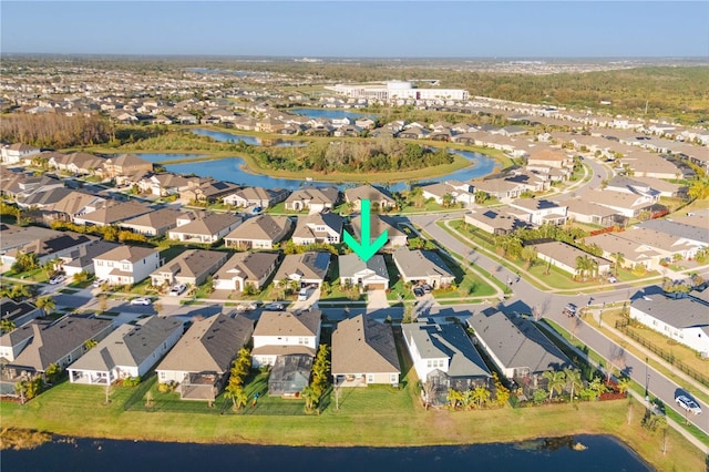 birds eye view of property featuring a water view and a residential view