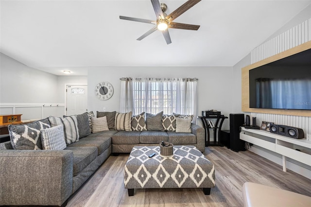 living area featuring vaulted ceiling, wood finished floors, and a ceiling fan