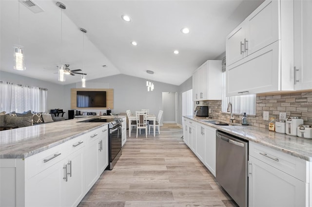 kitchen with electric stove, lofted ceiling, stainless steel dishwasher, open floor plan, and a sink