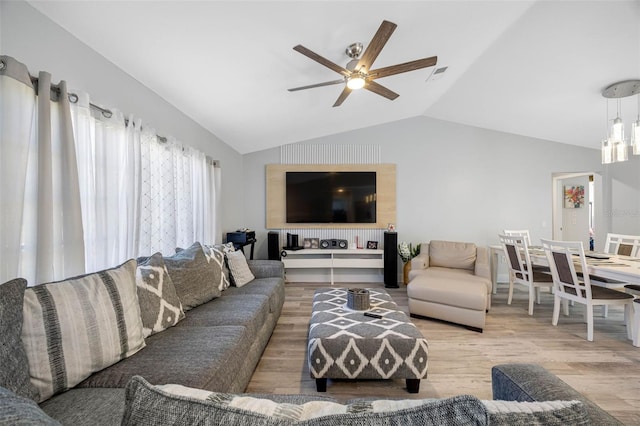 living room with lofted ceiling, a ceiling fan, and wood finished floors