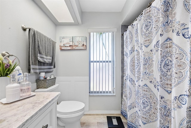 full bathroom featuring vanity, wood finished floors, toilet, and a shower with curtain