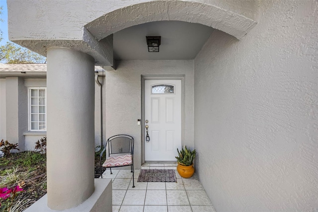 view of exterior entry featuring stucco siding