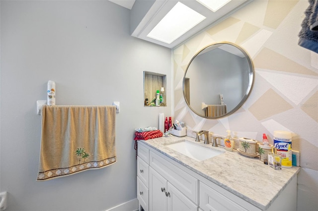 bathroom with a skylight and vanity