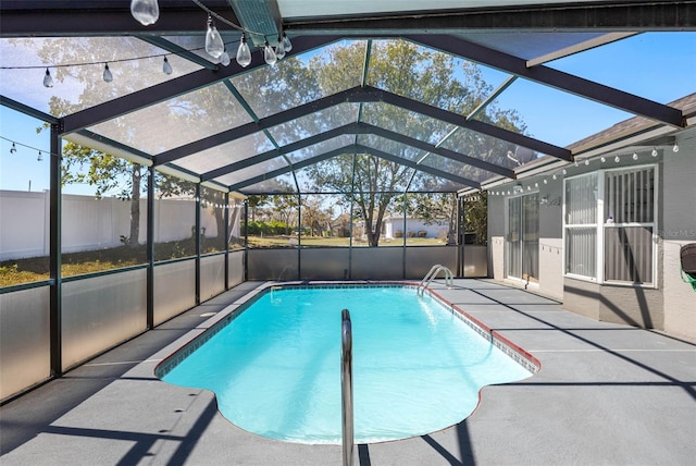 view of swimming pool with a fenced in pool, glass enclosure, and a patio