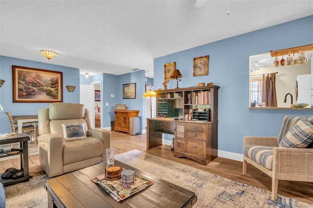 living area with light wood finished floors and baseboards