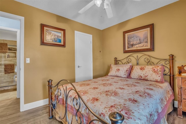 bedroom featuring ceiling fan, wood finished floors, and baseboards