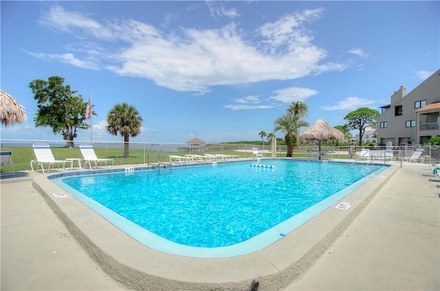 community pool featuring a patio and fence