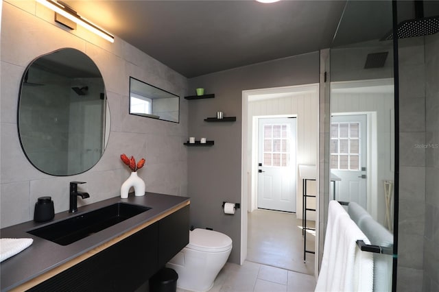 bathroom featuring a shower, backsplash, tile walls, and toilet