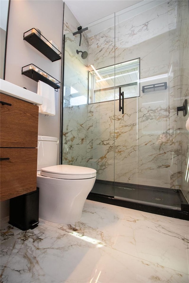 full bath featuring toilet, marble finish floor, a marble finish shower, and vanity