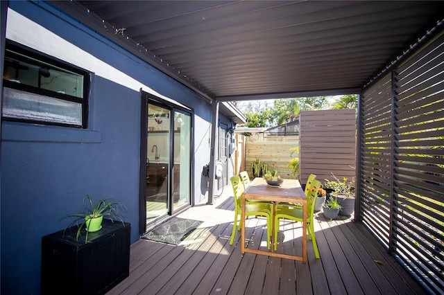 deck featuring fence and outdoor dining space