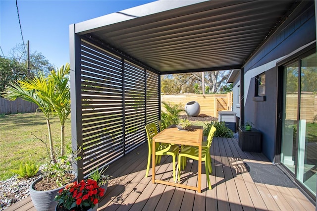 wooden terrace with fence and outdoor dining space