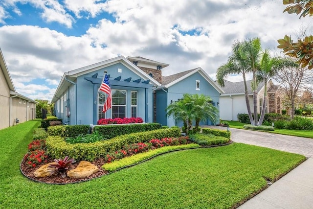 view of front of property featuring a garage, stucco siding, decorative driveway, and a front yard