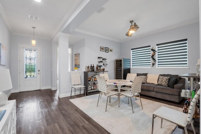 dining room with baseboards, visible vents, ornamental molding, dark wood-style flooring, and ornate columns