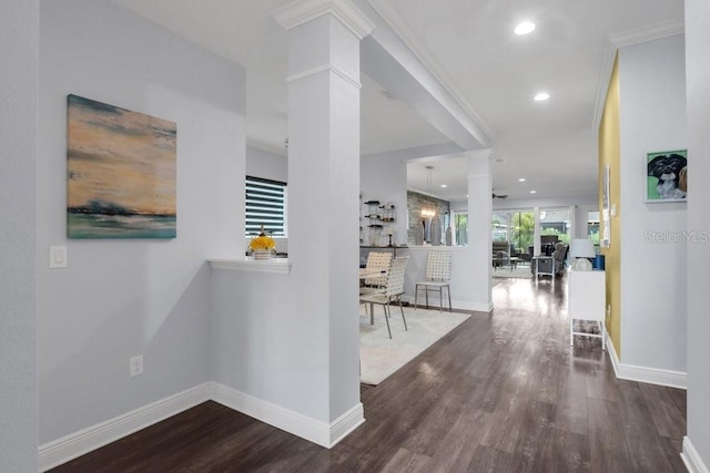 hall with recessed lighting, ornate columns, ornamental molding, wood finished floors, and baseboards