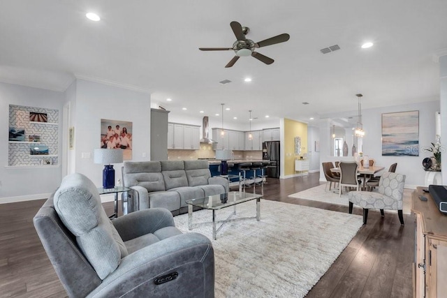 living area with recessed lighting, visible vents, dark wood finished floors, and baseboards