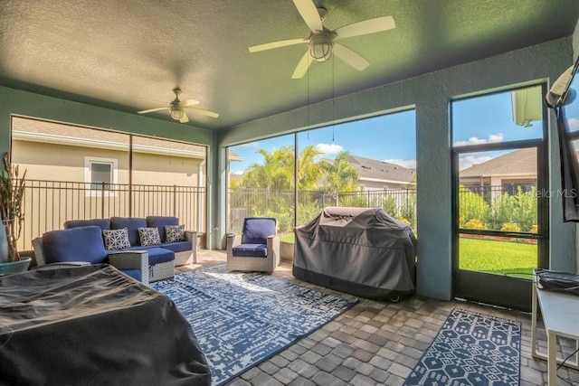 sunroom / solarium with a ceiling fan