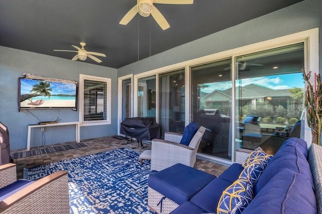 view of patio with ceiling fan, grilling area, and an outdoor living space