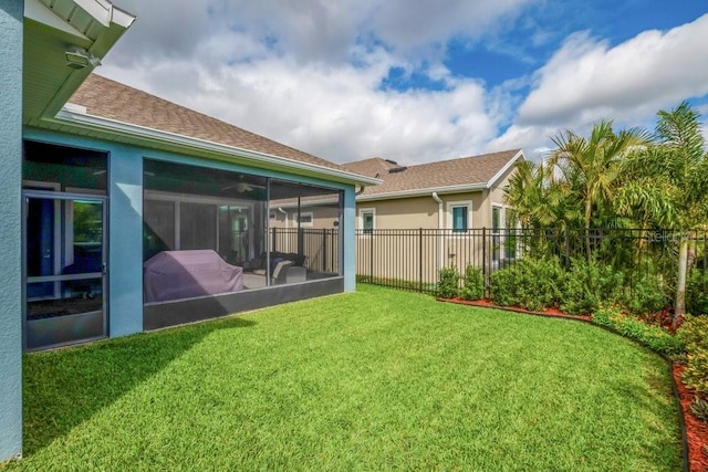 view of yard featuring a sunroom and fence