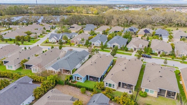 drone / aerial view with a water view and a residential view