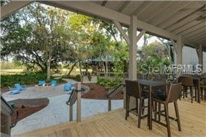 view of patio / terrace with outdoor dining area and a deck