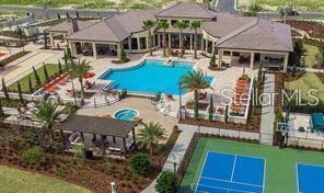 community pool with a patio area and fence