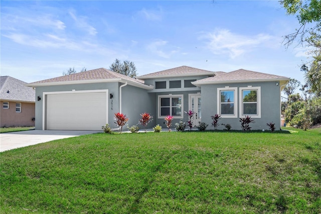 view of front of house featuring a garage, a front yard, concrete driveway, and stucco siding