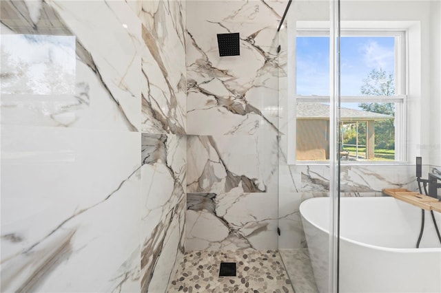 full bathroom with a soaking tub and a marble finish shower