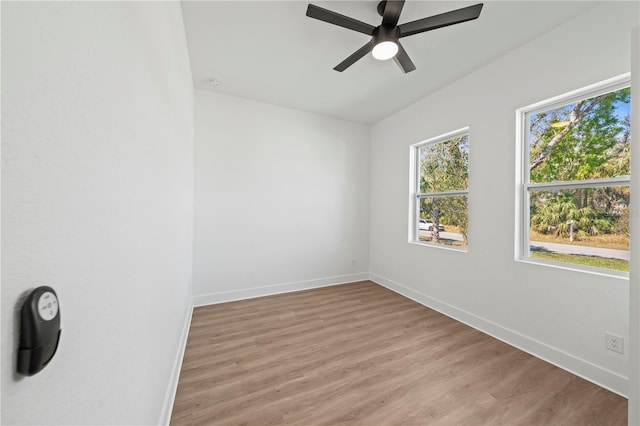 spare room with light wood-style flooring, baseboards, and ceiling fan