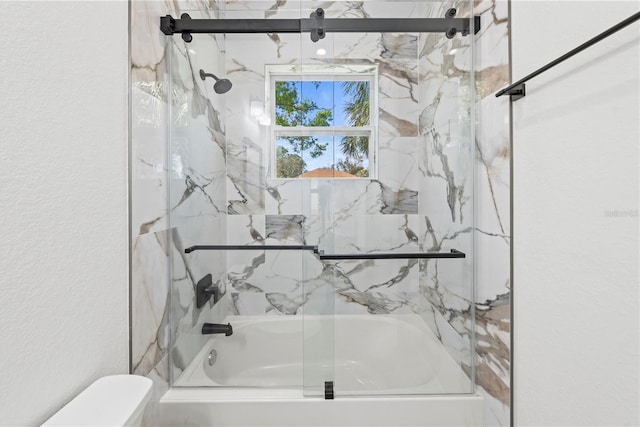 bathroom with enclosed tub / shower combo, a textured wall, and toilet