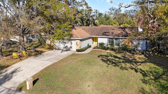 view of front of home featuring a garage, concrete driveway, a front lawn, and stucco siding