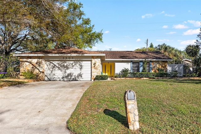 view of front of house with an attached garage, concrete driveway, stone siding, stucco siding, and a front lawn