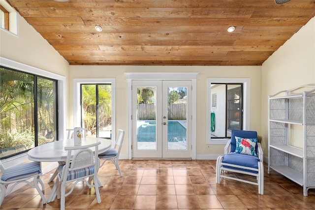 sunroom / solarium featuring vaulted ceiling, french doors, and wooden ceiling